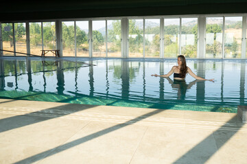 Tourist relaxing in thermal pool enjoying summer holidays