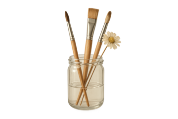 Glass jar holds paintbrushes and daisy, artistic still life