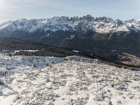 Snowy mountain landscape with a view of jagged peaks and a valley below. Paganella, Roda refuge,Trentino, Italy
