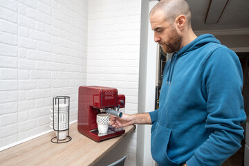 Man preparing coffee in his home kitchen