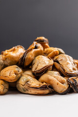 Pickled Mussels in Plastic Container on Dark Background