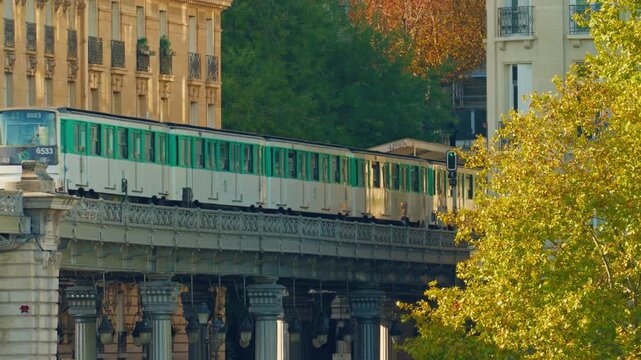 Paris, France - 26.08.2025 : The parisian urban subway passes over a bridge. The oldest green metro line, number 6 in Paris