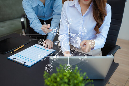 Modern technology and networking concept, woman using laptop,tablet and smartphone with virtual screen API icon Software development tool. API Application Programming Interface.