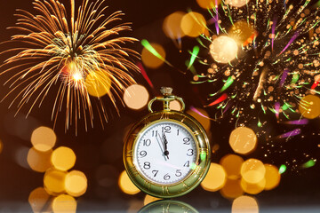 Happy New Year! Countdown clock on abstract glittering background with fireworks.