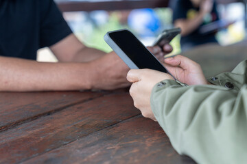 A close-up view of multiple people using smartphones, symbolizing modern social media interaction.