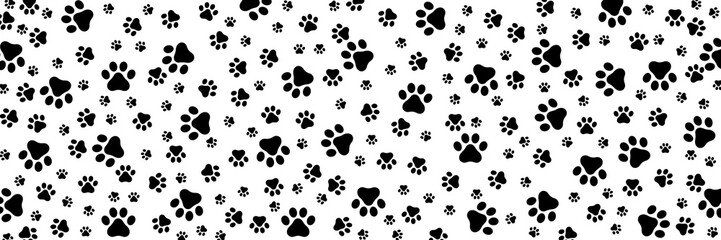 Many black cat paw prints of various sizes on transparent background, wide background © Satou Akira