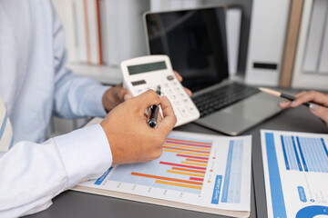 Business colleagues reviewing budget charts together in a modern office, focusing on financial insights, performance metrics, and strategic planning to support upcoming business decisions.