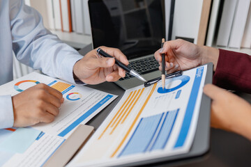 Business colleagues reviewing budget charts together in a modern office, focusing on financial insights, performance metrics, and strategic planning to support upcoming business decisions.