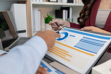 Business colleagues reviewing budget charts together in a modern office, focusing on financial insights, performance metrics, and strategic planning to support upcoming business decisions.