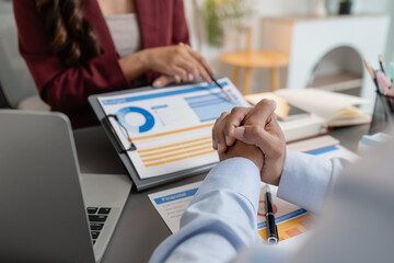 Business colleagues reviewing budget charts together in a modern office, focusing on financial insights, performance metrics, and strategic planning to support upcoming business decisions.