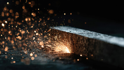 Close-up view of the welding process, capturing the sparks of welding torch