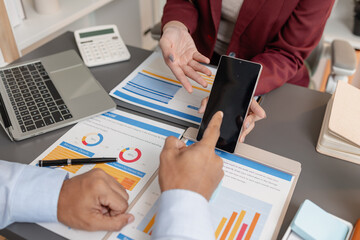 Business colleagues reviewing budget charts together in a modern office, focusing on financial insights, performance metrics, and strategic planning to support upcoming business decisions.