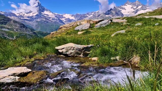 best hikes in Zermatt, the Five Lakes Trail (5-Seenweg) most famous hiking routs in Switzerland , Valais canton 4k hd video of steraming water at Stellisee lake and epic view of Matterhorn mountain