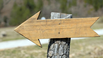 Follow the rustic wood arrow sign for adventure and exploration in nature and the great outdoors