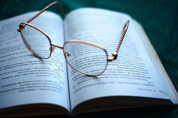 glasses on a book, learning and business © Mariusz
