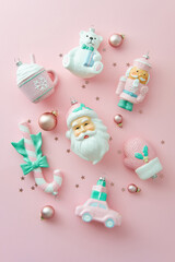 Sweet pastel pink Christmas ornaments on pink background.