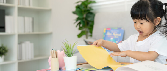 Happy Asian children relax read book at home. daughter and reading a story. learn development, childcare, laughing, education, storytelling, practice, imagine, reduce addiction mobile phone