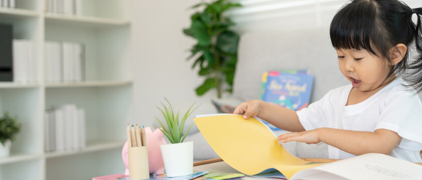 Happy Asian children relax read book at home. daughter and reading a story. learn development, childcare, laughing, education, storytelling, practice, imagine, reduce addiction mobile phone