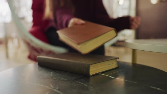 vintage book collection showcased beautifully, closeup of stacked old books in cozy bookstore setting, displaying classic literature with comfortable seating in warmly decorated shop