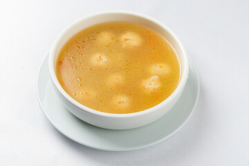 Delicious broth with floating dumplings creates a warm and inviting atmosphere in a kitchen