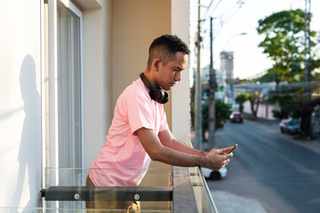 Millennial man checking phone in afternoon light