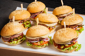 A vibrant display of gourmet burgers with fresh toppings, showcasing the essence of summer feasting