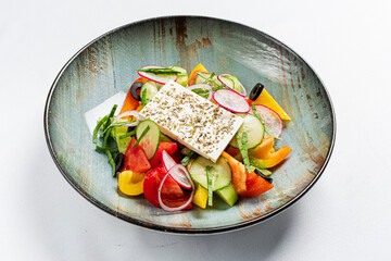 Fresh and colorful vegetable salad featuring cucumber, tomatoes, and bell peppers with feta