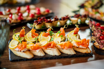 Colorful appetizers feature smoked salmon, lemon, and fresh herbs served at a vibrant event