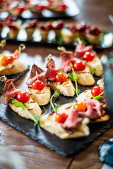 Colorful bites featuring meat, fresh tomatoes, and herbs delight guests during a joyful celebration