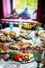 Delicious array of salads, fruits, and snacks shared during a joyful gathering in a cozy setting