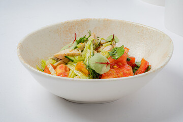 Crisp vegetables and tender chicken create a delicious salad served in a charming bowl