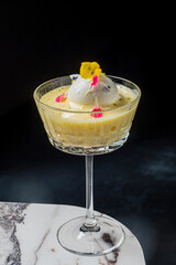A creamy dessert adorned with colorful flowers and whipped cream showcases culinary artistry