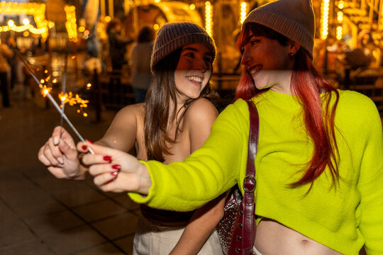 Gen z friends enjoying night with sparklers in valencia - Powered by Adobe