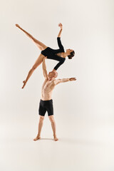 Fototapeta premium Dynamic duo showcases acrobatic skills in a vivid and graceful performance