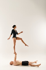 Acrobatic dance performance showcases agility and balance in a minimalistic setting