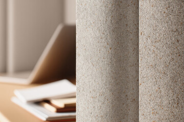 Modern privacy booth in office with textured stone wall, soft natural light, and blurred workspace background creates calm and focused environment for productivity
