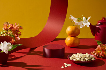 Festive composition with traditional snacks, fruits, and floral decorations placed on yellow background. Ideal for seasonal product displays, empty podium