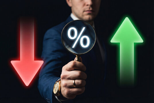 Business analysis of fluctuating percentage rates highlighted through magnifying glass with rising and falling financial indicators.