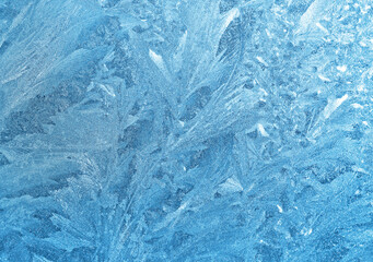 Ice pattern on window glass, close-up natural winter texture