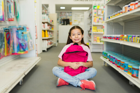 Young girl buying school supplies for back to school