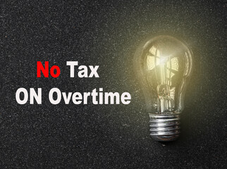 Text no tax on overtime. light bulb on a gray background. Symbolism Business Concept