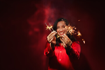  successful business woman celebrating, isolated on red light background with copy space.