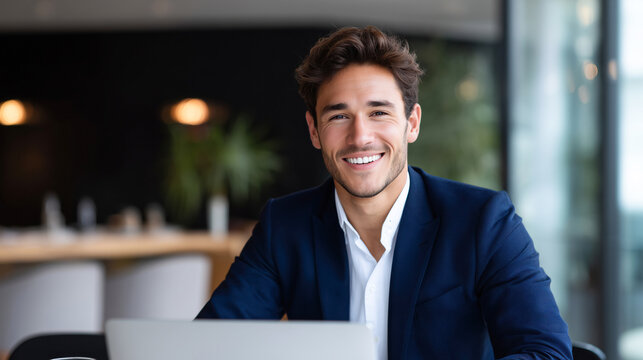 Confident young professional working on a laptop in a modern office, representing productivity and contemporary business culture