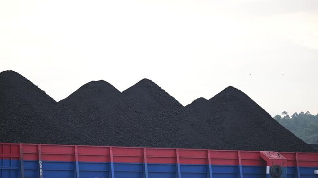 Berau - Indonesia, 25 August 2025 : pontoon loading coal with white clouds in the background
