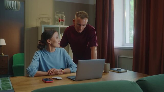 Boss man checks scold asian woman subordinate do task incorrectly mistake fail report. Management dissatisfied work. Employee wrong answer, bug fixes, error correction. Bad job. Guy show laptop screen