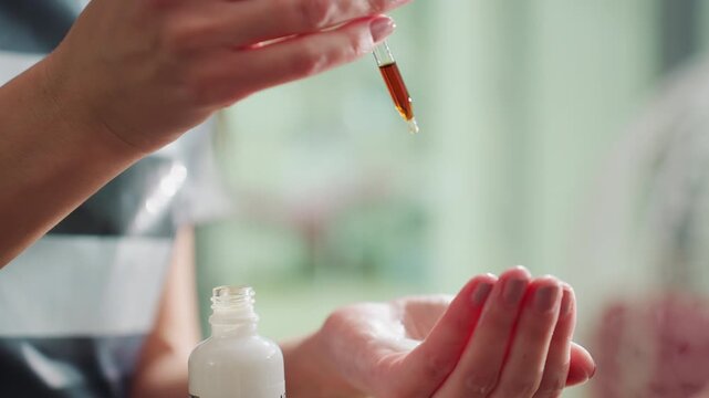 professional skincare specialist blending tailored serum in salon setting, experienced beautician carefully combining custom amber serum using precise pipette measurements in salon environment