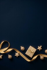 Christmas or New Year background with gift box and fir branch decorations on dark blue backdrop. empty copy space for text.holiday and celebration concept for postcard or invitation. top view