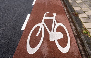 Typical dutch red cycling lane alongside the road