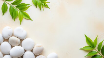Spa concept with white pebble stone and green leaf on beige background