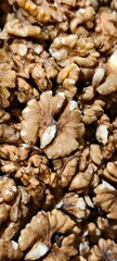 Close-up of raw walnut halves showing detailed texture and natural brown tones.Ideal for illustrating healthy eating, plant-based nutrition, or culinary ingredients.